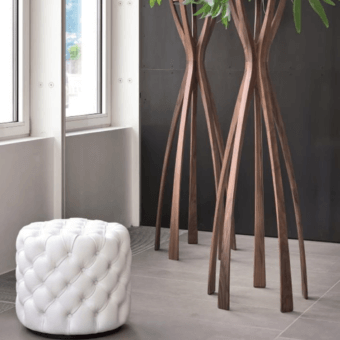 Elegant Porada Alcide ottoman with creamy white fabric upholstery and classic tufted detailing