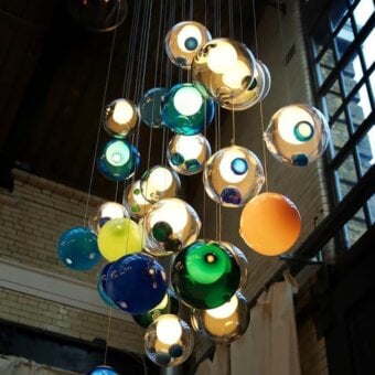 Distinguished Bocci 28 Random suspension lamp crafted with clear glass spheres exhibiting blue, green, and orange hues with captivating internal textures