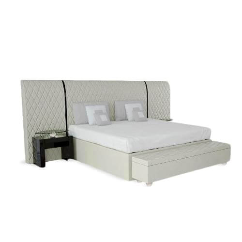 Light platform with vertically padded panel displaying diamond stitching and white cushions arranged on a textured surface