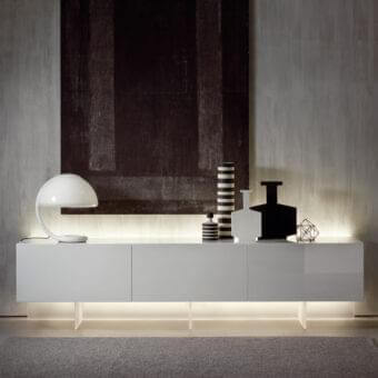 Exceptional Acerbis N.C. sideboard crafted with glossy white synthetic material and illuminated recessed base offering horizontally aligned compartments