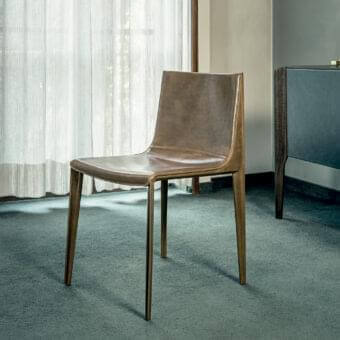 Exceptional Arketipo Emily chair with wide seating and low back upholstered in smooth brown vegetable-tanned Dirt leather with visible stitching