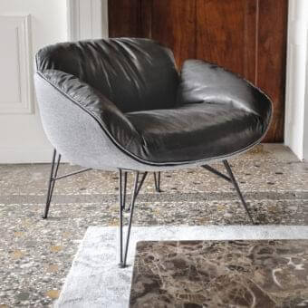 Sophisticated Arketipo Juno lounge chair with black leather-like upholstery and gray woven textile built on dark metal feet