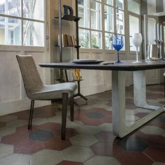 Elegant Arketipo Venus chair with light gray textile upholstery and a dark metal frame offering a smooth finish