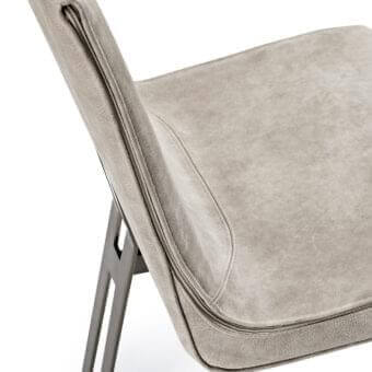 Sophisticated Arketipo Venus chair in muted grey textile with enveloping metal legs and sinuous upholstered form
