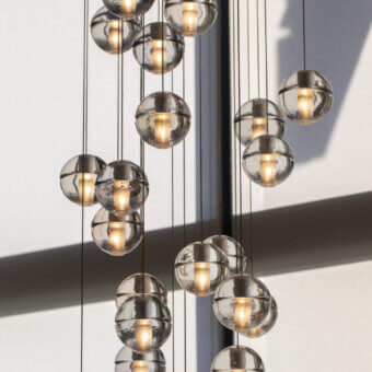 Elegant Bocci 14 Random Suspension lamp with articulated cast glass spheres in neutral gray and frosted cylindrical voids