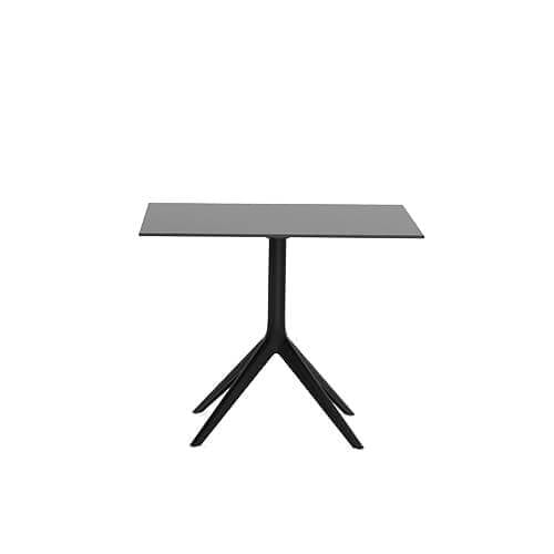 Dark square surface on flared four-legged base against a plain white background with even lighting