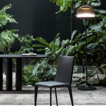 Elegant Bonaldo Filly chair with smooth dark gray fabric upholstery and slim dark gray metal legs