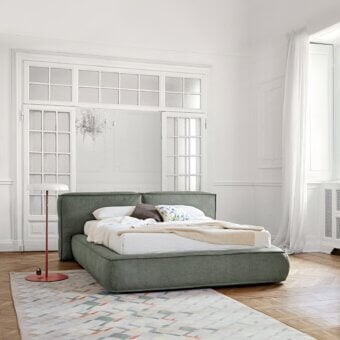 Superior Bonaldo Fluff bed with rounded design upholstered in muted green textile exhibiting a matte finish