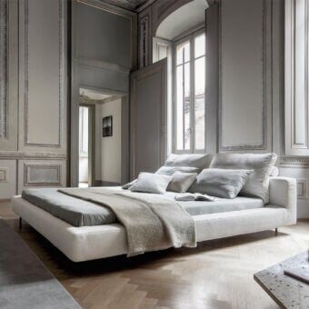 Elegant Bonaldo Owen bed with light beige woven upholstery and dark painted metal feet creates a minimalist silhouette