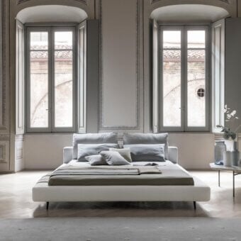 Superior Bonaldo Owen bed with soft gray fabric upholstery and slender dark painted metal feet