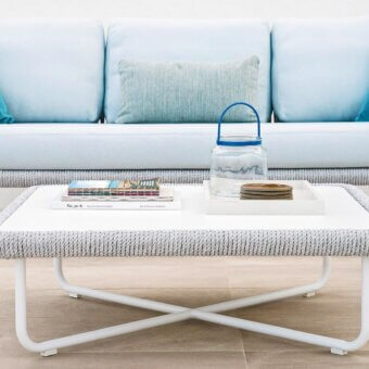 Distinguished Varaschin Babylon coffee table with a matt-gray painted aluminum frame and woven synthetic fiber detailing, built with a white HPL top