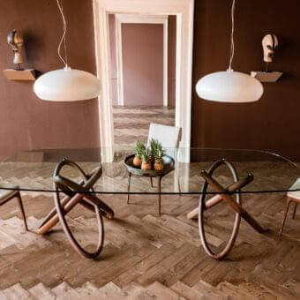 Superior Cattelan Italia Carioca table with clear glass top and sculpted solid Canaletto walnut base exhibiting a smooth finish