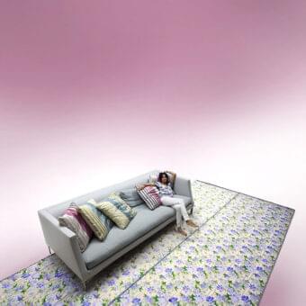 Sophisticated Erba Altoborgo sofa with a matt metal frame and light gray textile upholstery accented with colorful cushions and satined chrome feet