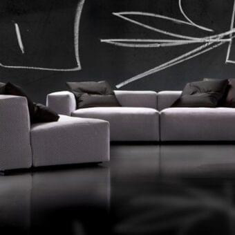 Exceptional Erba Aspettami sectional sofa with patterned light and dark gray textile and cylindrical steel bars crafted in Italy
