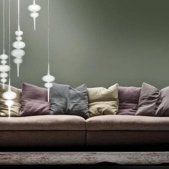 Exceptional Erba Atollo sofa with muted brown fabric upholstery and plush pillows in grey, mauve, beige tones