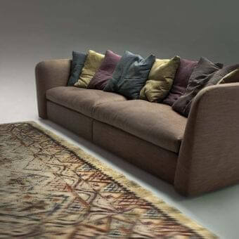 Exceptional Erba Atollo sofa with matte brown textile upholstery and decorative cushions in green, purple and gray