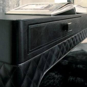 Distinguished Rugiano Coline desk with black leather cover and sleek steel metal details exhibiting matelassé embroidery