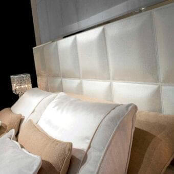 Distinguished Rugiano Gemma bed upholstered in white leather with a padded square headboard and bronze-toned metal trim