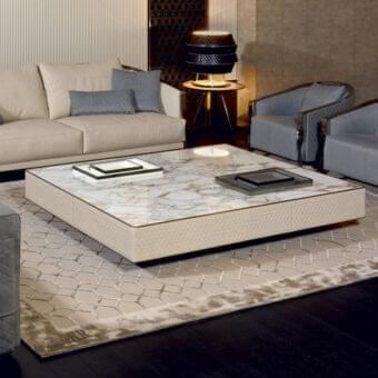Sophisticated Rugiano Hugo coffee table with a refined top and smooth finish paired with a geometric mosaic rug in neutral tones