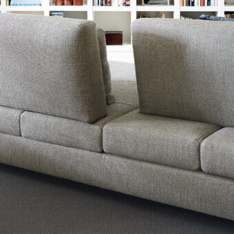 Elegant Swan Italia Hemingway sectional in neutral gray textured textile with a wooden frame and expanded polyurethane padding