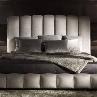 Exclusive DV Home Collection Byron bed with channeled headboard and footboard upholstered in light grayish-beige fabric or leather