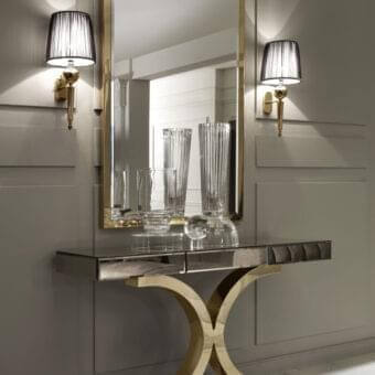 Superior DV Home Collection Kent Plus console with a dark wood tabletop and elaborately curved stainless steel base in a polished gold-tone finish