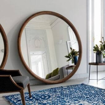 Exceptional Porada Giove mirror crafted in solid Canaletto walnut with a smooth satin finish and generous circular glass