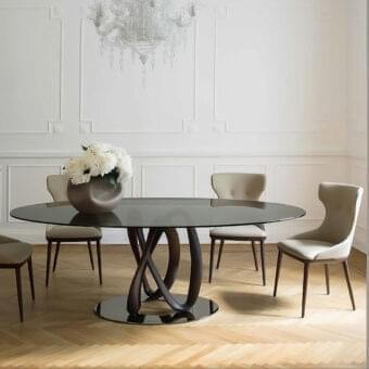 Captivating Porada Infinity table with clear glass and a Canaletto walnut pedestal built with a chrome plated metal ring