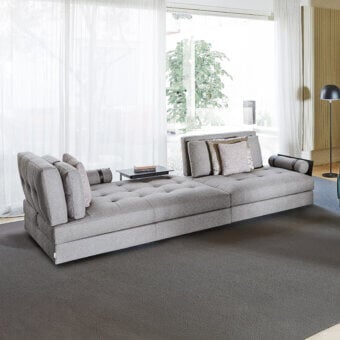 Sophisticated Swan Italia Hemingway sectional with gray textile upholstery and button-tufted cushions built with powder-coated metal feet