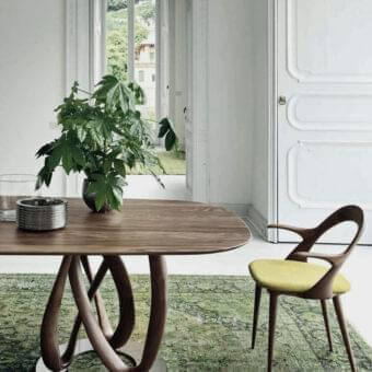 Distinguished Porada Infinity table with intertwined Canaletto walnut bases and Wengé stained finish supporting a dark brown wooden top