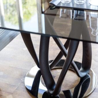 Superior Porada Infinity Glass Table with tempered glass and two sculptural Canaletto walnut wengé stained bases with polished chrome finish