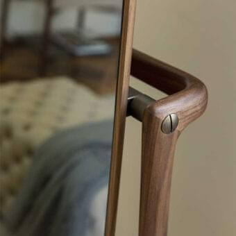 Exceptional Porada Timothy mirror with solid canaletto walnut frame and bronzed brass details exhibiting a medium-toned finish
