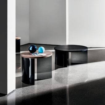 Distinguished Sovet Italia Regolo coffee table with dual circular tiers in warm wood and deep-black lacquered laminated glass with a matte finish
