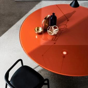 Sophisticated Sovet Italia Totem table with vibrant orange tempered glass and lacquered metal base creates a sleek design