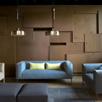 Elegant Verzelloni Fold sofa with light blue textile upholstery and chrome cast feet crafted in solid wood and plywood