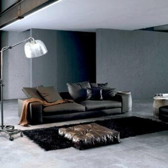 Distinguished Verzelloni Holden sofa with muted gray woven fabric upholstery and matte finish, supported by black-stained beech feet with a golden-brown bolster