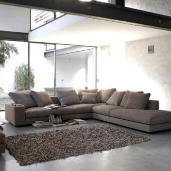 Superior Verzelloni Holden sectional with warm gray textile upholstery and black-stained beech feet