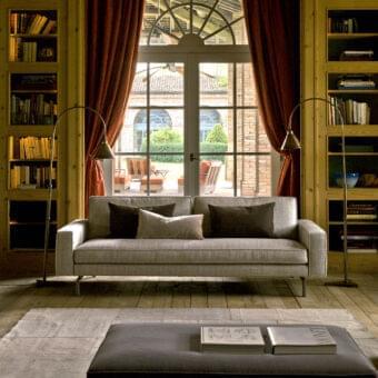 Distinguished Verzelloni Irving sofa with muted gray textured upholstery and bronzed painted aluminium bridge feet