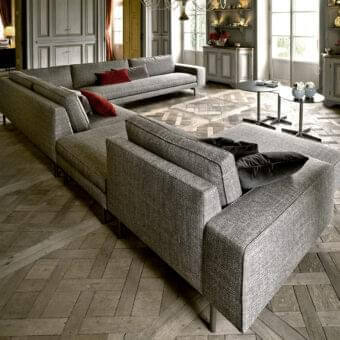 Elegant Verzelloni Irving sectional with textured light gray textile and bronzed painted aluminum cast feet