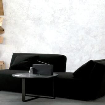 Distinguished Verzelloni Itaca sofa with a low, wide form in black textile and black-stained beech feet