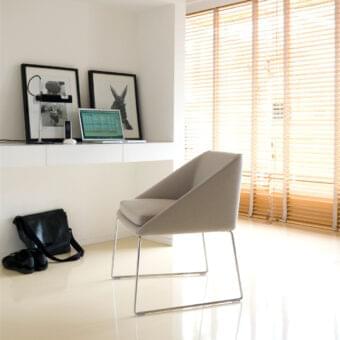 Distinguished Verzelloni Kelly armchair with neutral beige textile upholstery and chrome-finished metal framework