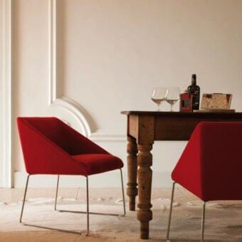 Superior Verzelloni Kelly armchair upholstered in vibrant red textile with a sleek chrome finished metal frame