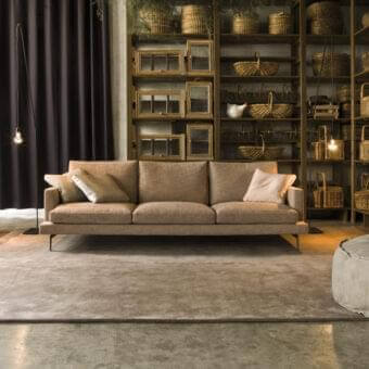 Distinguished Verzelloni Larsen sofa with muted beige textile upholstery and dark bronze-finished aluminium cast legs