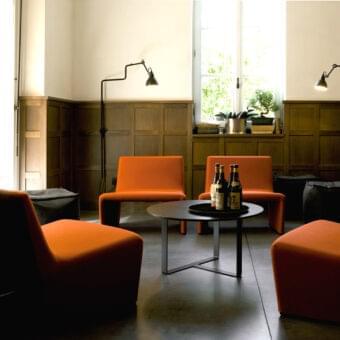 Distinguished Verzelloni Patty lounge chair with vibrant orange woven textile upholstery and matte finish
