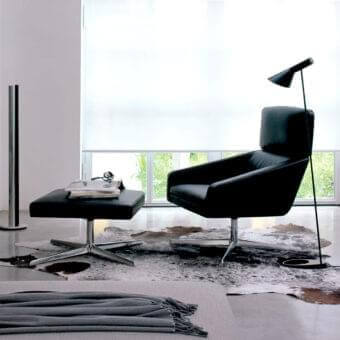 Superior Verzelloni Sillon lounge chair with dark leather upholstery and polished cast aluminum swivel base