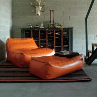 Exceptional Verzelloni Zoe lounge chair with smooth glossy orange leather-like material and visible seams