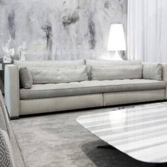 Distinguished Erba Alchimia sofa with light gray textile upholstery and a contrasting lighter base crafted with solid wood frames