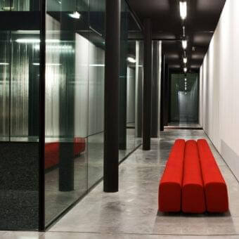 Elegant LaCividina Osaka bench with organic curves and vibrant red stretch fabric upholstery over a steel structure
