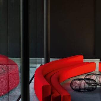 Exceptional LaCividina Osaka sofa with curvy organic lines upholstered in bright red stretch fabric and steel structure