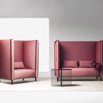 Captivating LaCividina Pinch sofa with cocoon-like form in muted rose textile and dark metal base